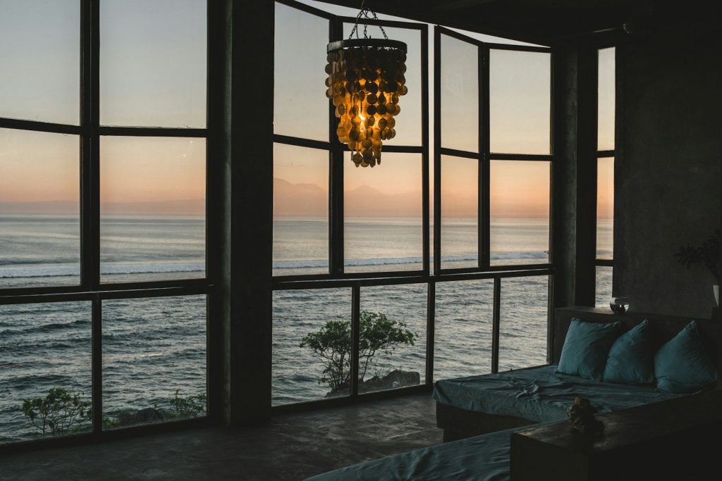 Modern room with ocean view at sunset